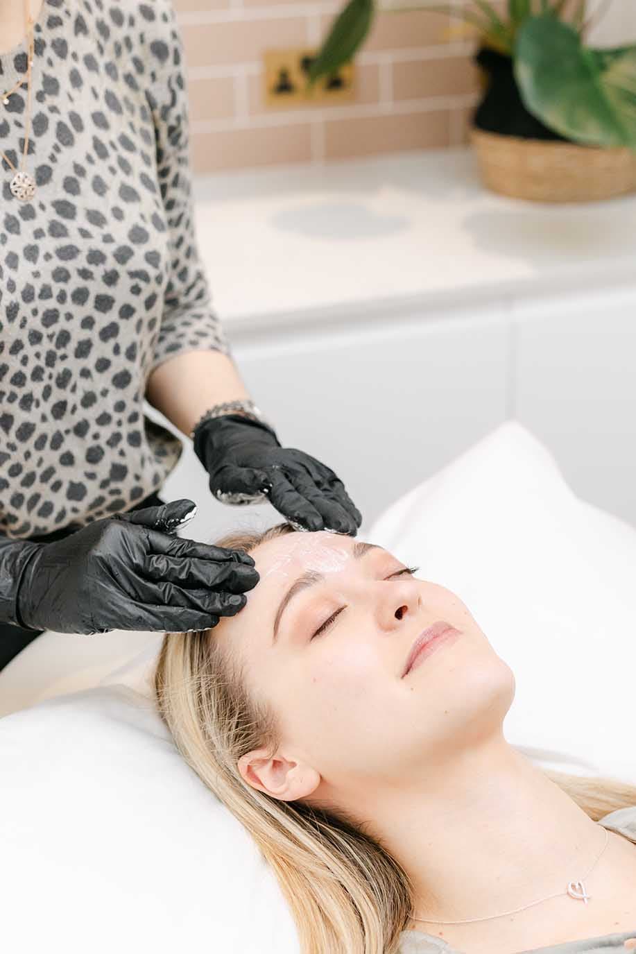 gloved-hands-forehead-pillow-treatment